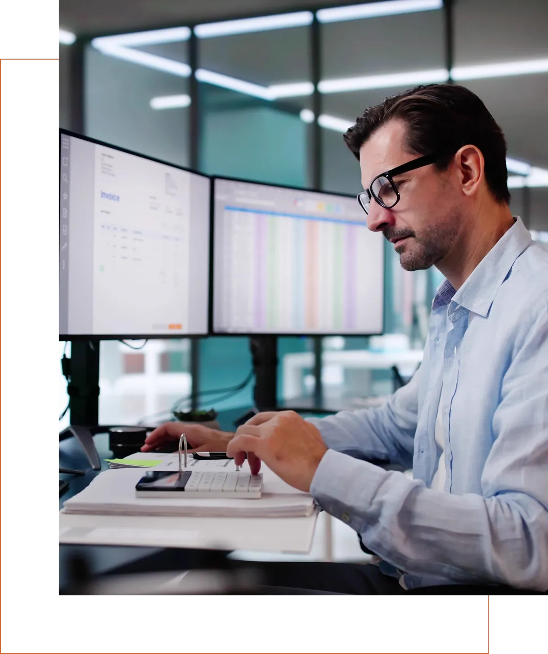 Man working at dual monitors in an office